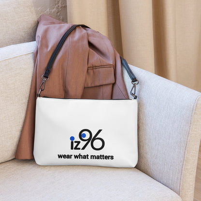 White bag with 'iz96 wear what matters' logo on a beige couch