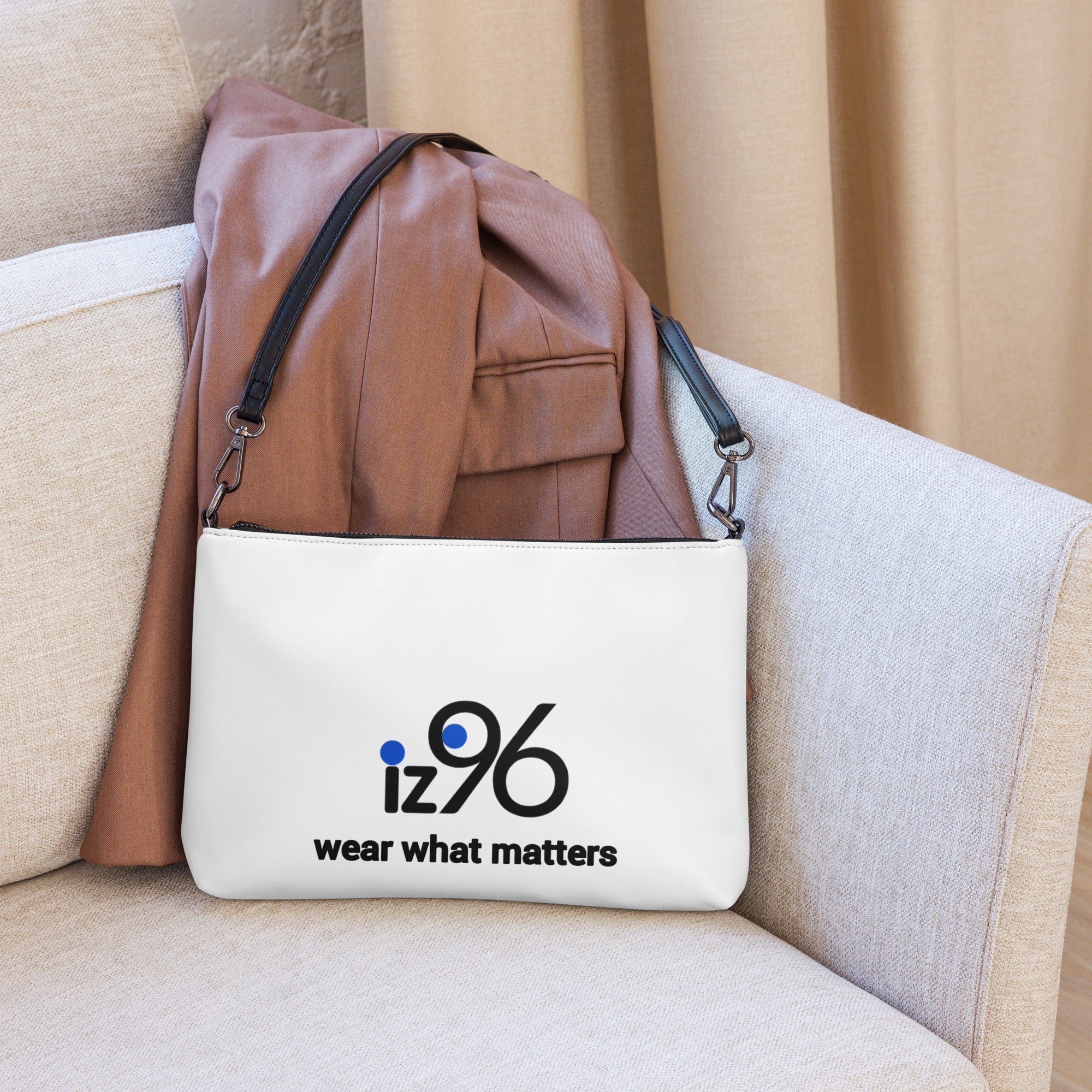 White bag with 'iz96 wear what matters' logo on a beige couch