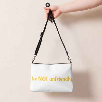 White bag with 'be NOT unfriendly' text held by a hand against a beige background