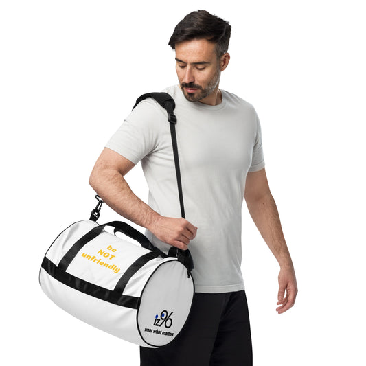 Man holding a white duffel bag with black straps on a white background