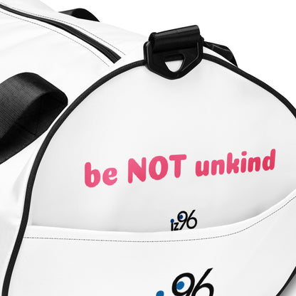 Person holding a white duffel bag with 'be not unkind' text on a white background