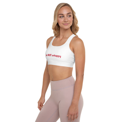 Woman wearing a white sports bra with red text and pink leggings on a white background