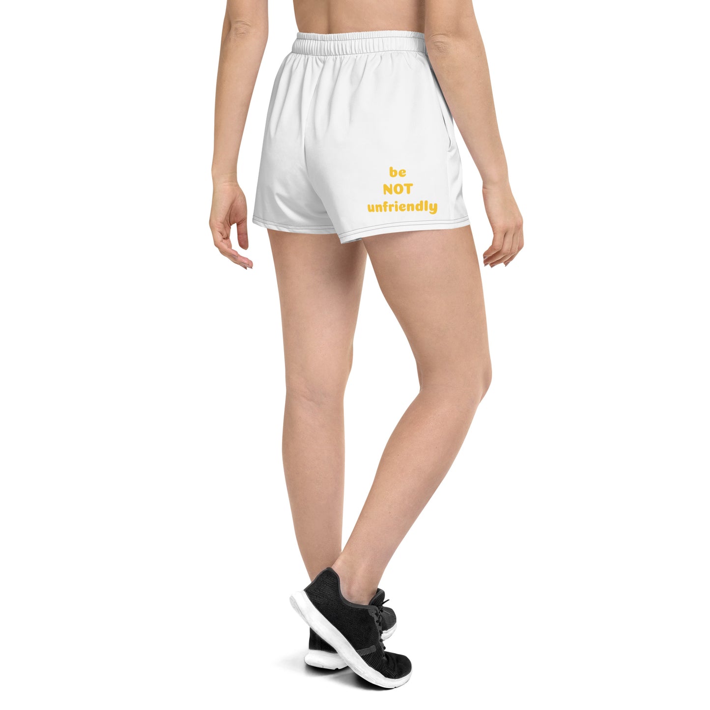 White shorts with yellow text worn by a person on a white background
