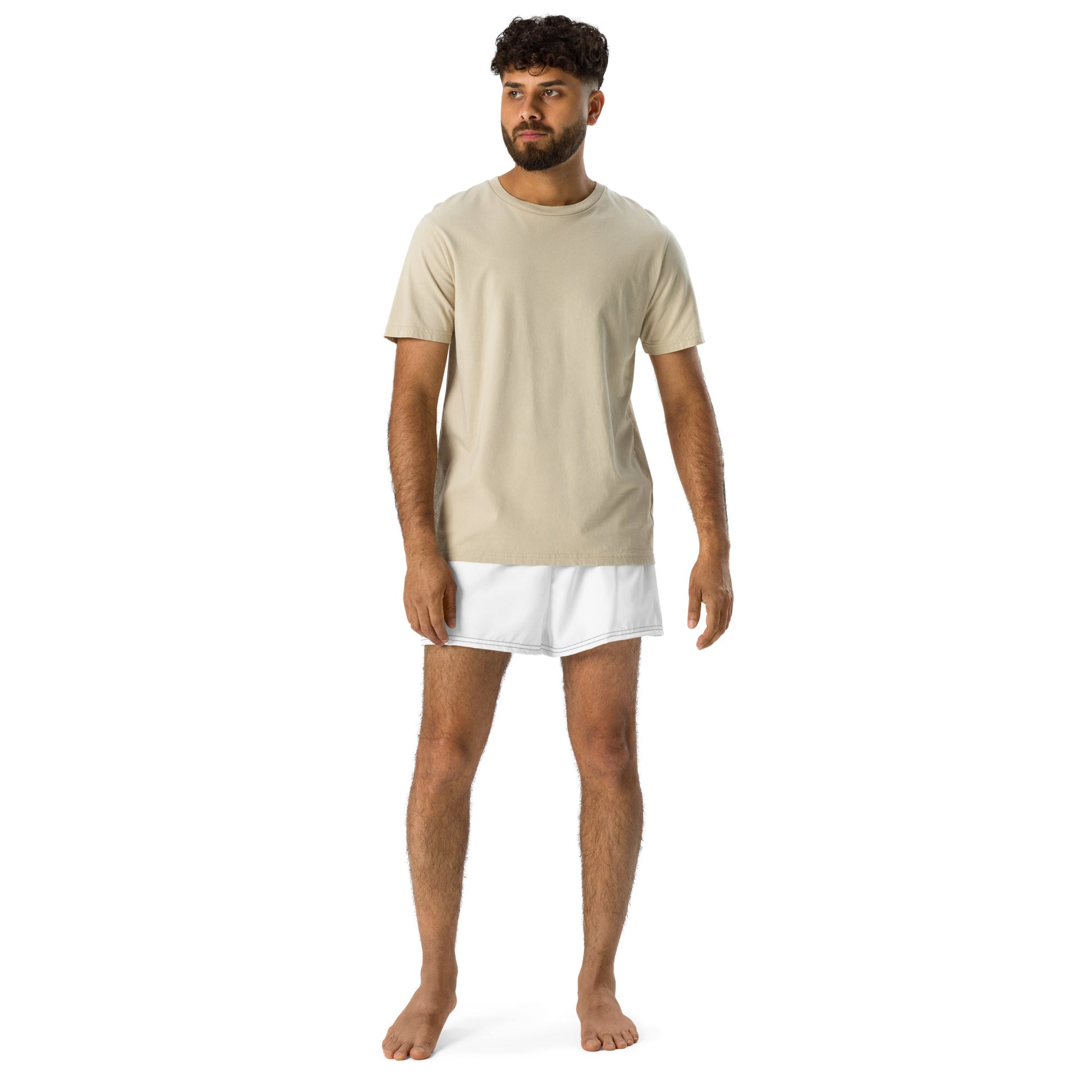 Man wearing a beige t-shirt and white underwear on a white background