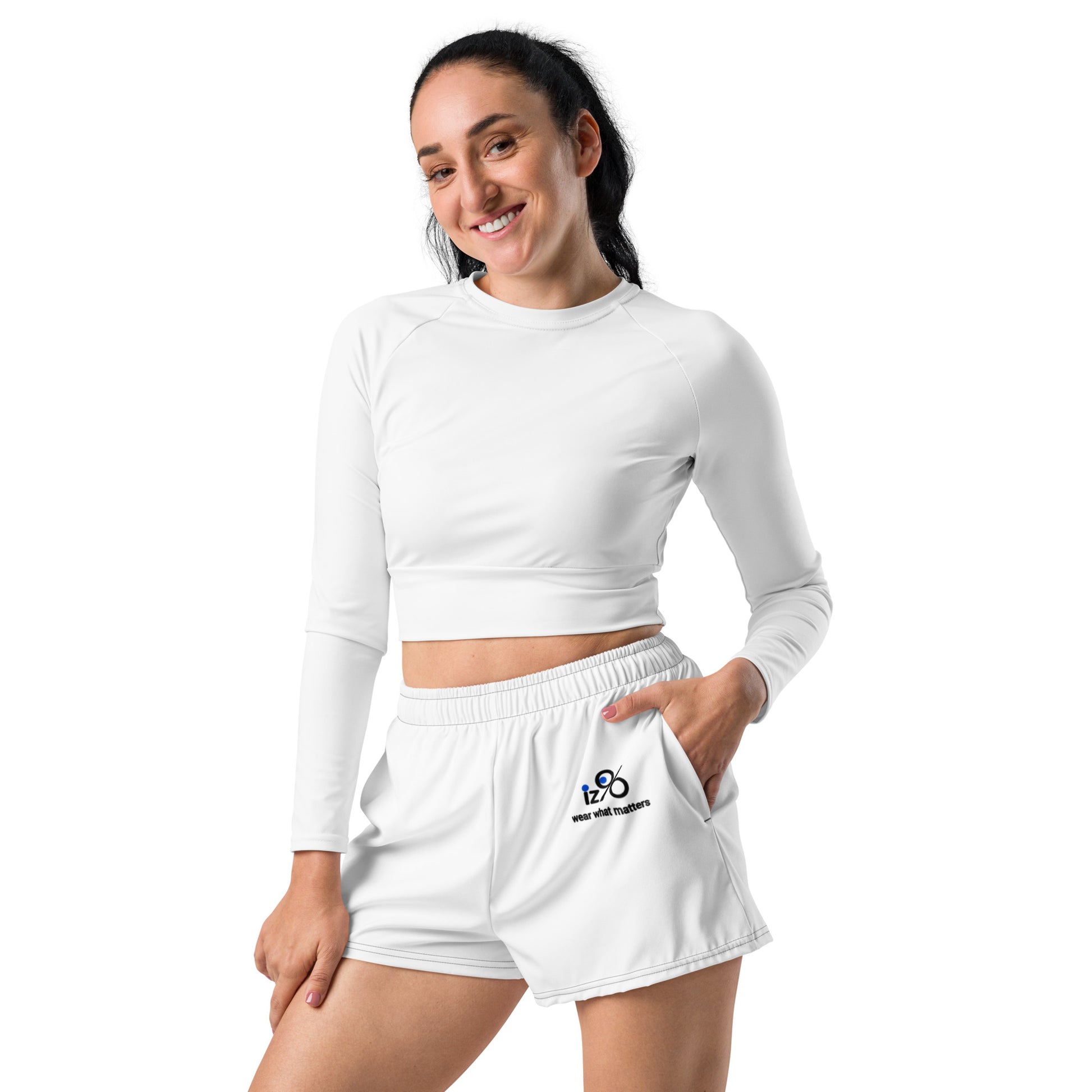 Woman wearing a white long-sleeve crop top and shorts on a white background