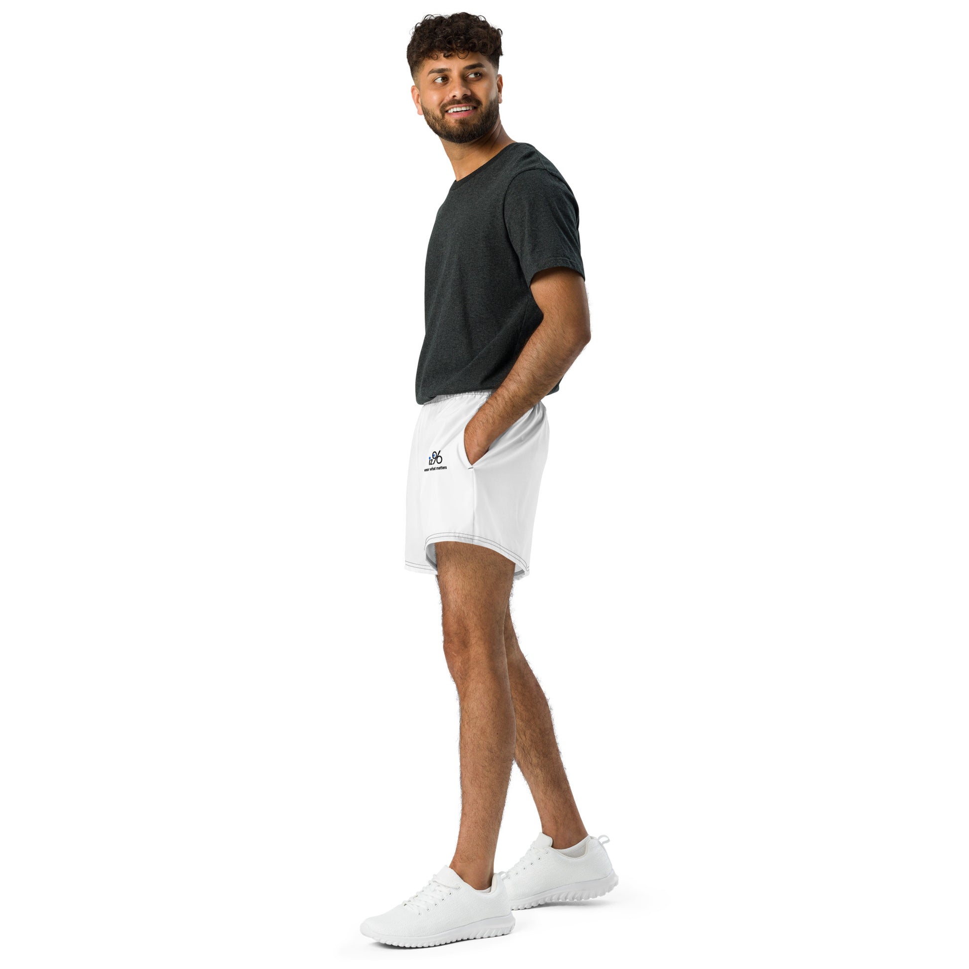 Man wearing a black t-shirt and white shorts with a brand logo on a white background