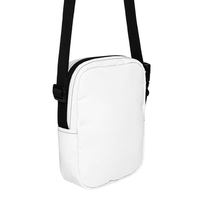 White crossbody bag with a black strap on a white background