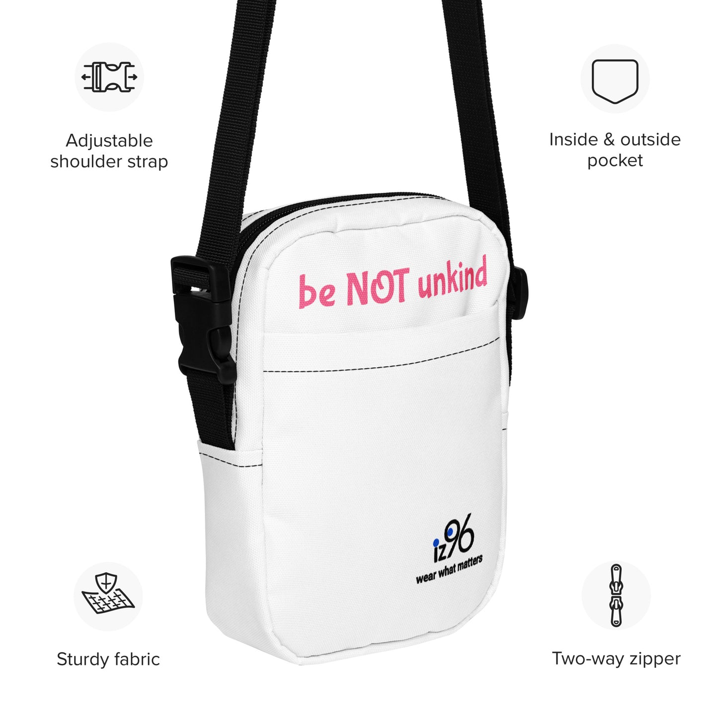 White bag with pink text 'be NOT unkind' and black strap, featuring icons and text describing features.