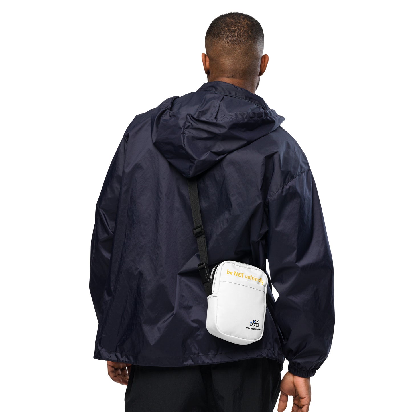 Person wearing a navy raincoat with a white bag on a white background