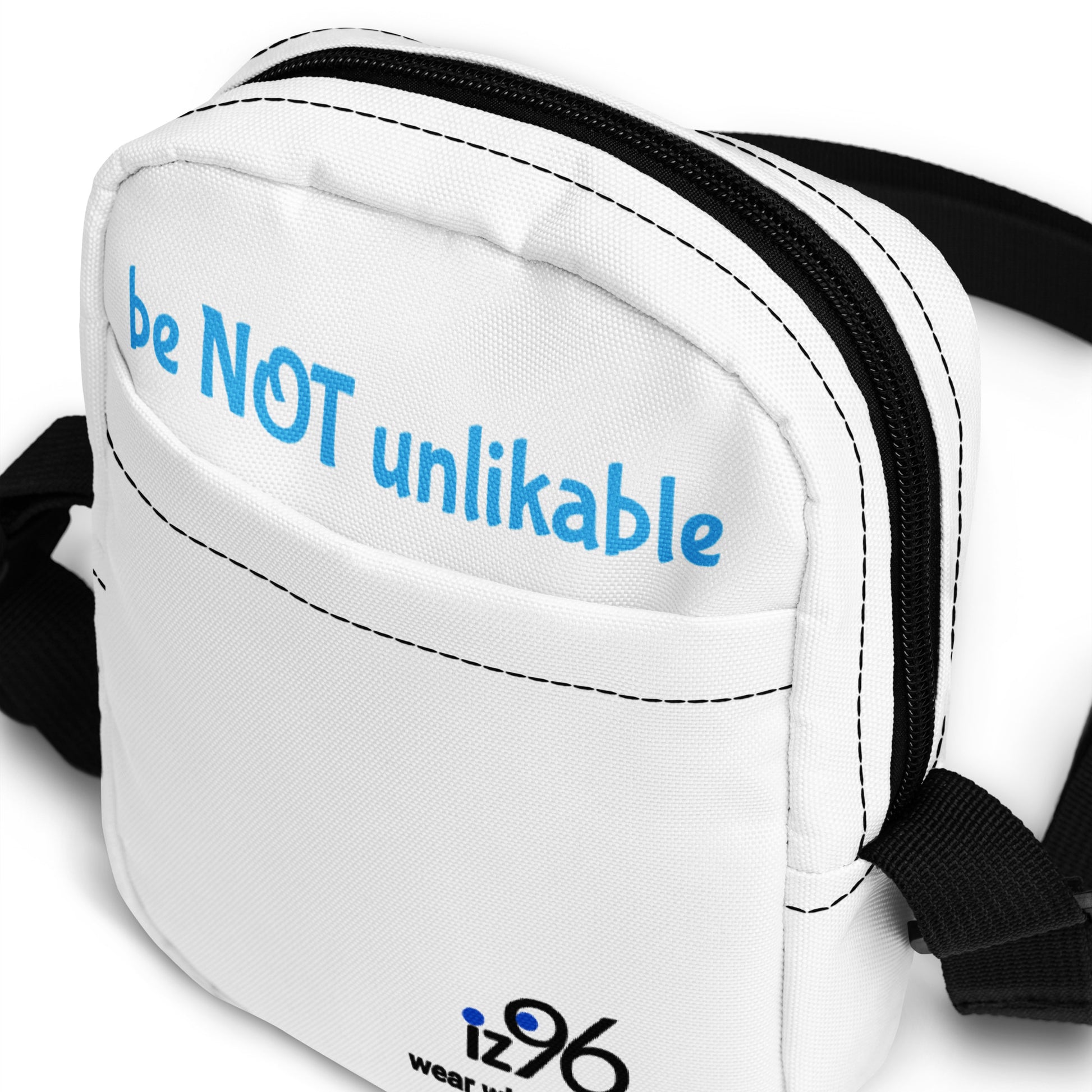 White waist bag with 'be NOT unlikable' text and iz96 logo on a white background