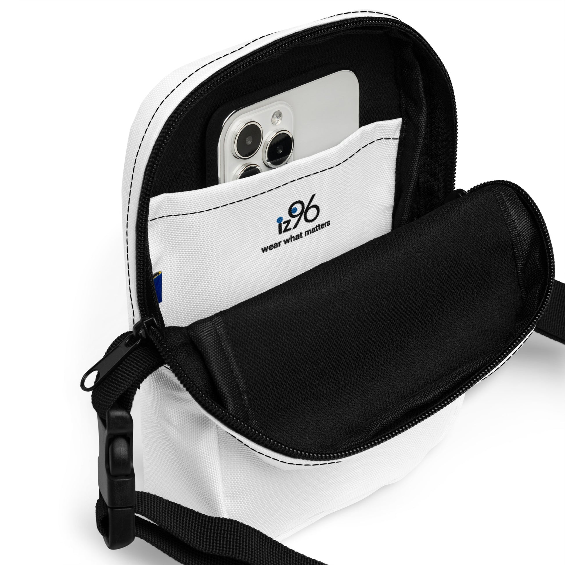 Black crossbody bag with a phone inside on a white background