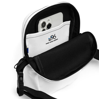 Black crossbody bag with a phone inside on a white background