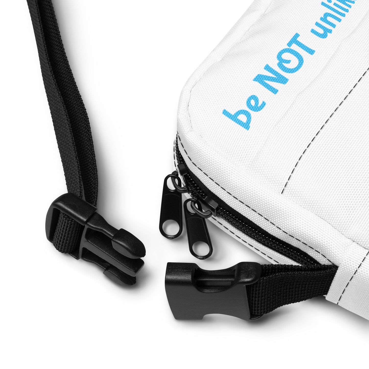White pouch with black strap and zipper, featuring the text 'be NOT unlikable' on a white background.