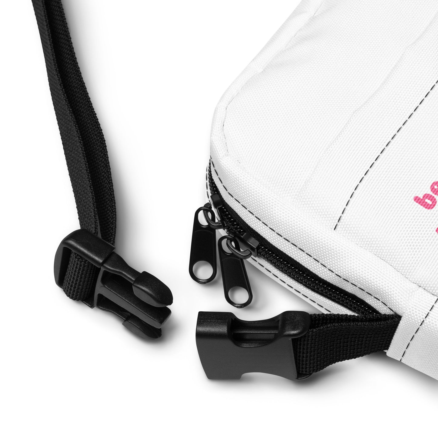Close-up of a white bag with black zippers and straps on a white background