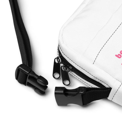 Close-up of a white bag with black zippers and straps on a white background