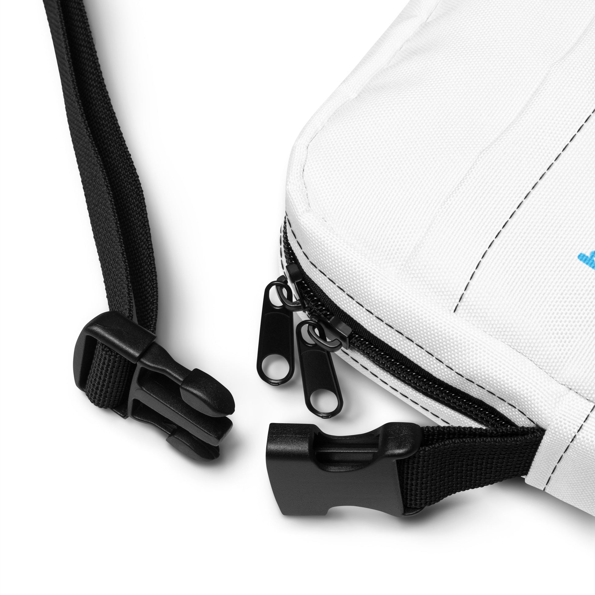 Close-up of a white bag with black zipper and strap on a light gray background