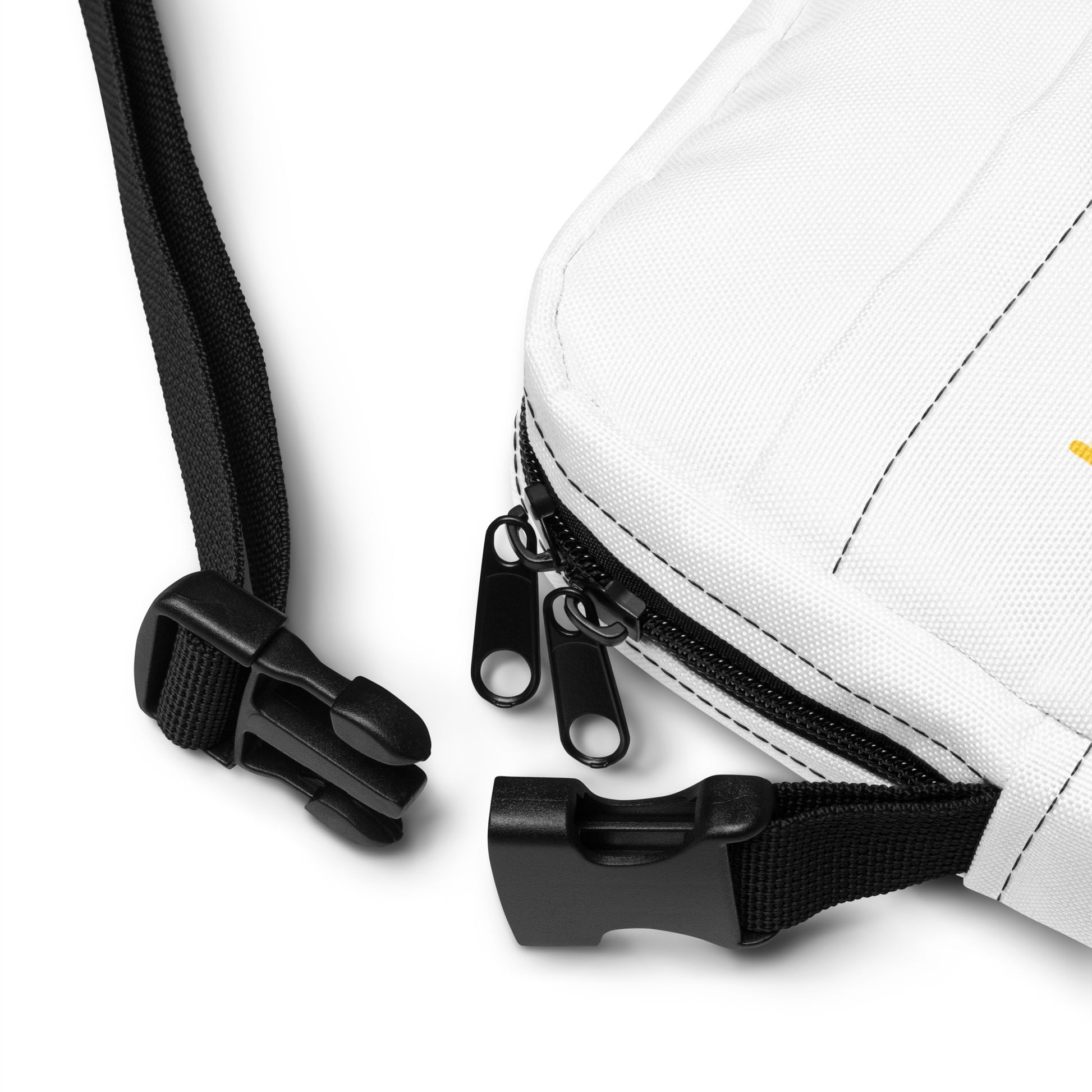 Close-up of a white bag with black zipper and strap on a light gray background