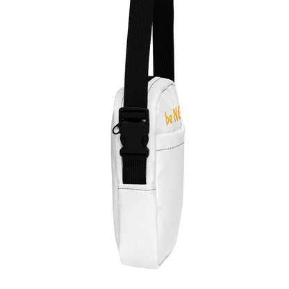 White crossbody bag with black strap on a white background