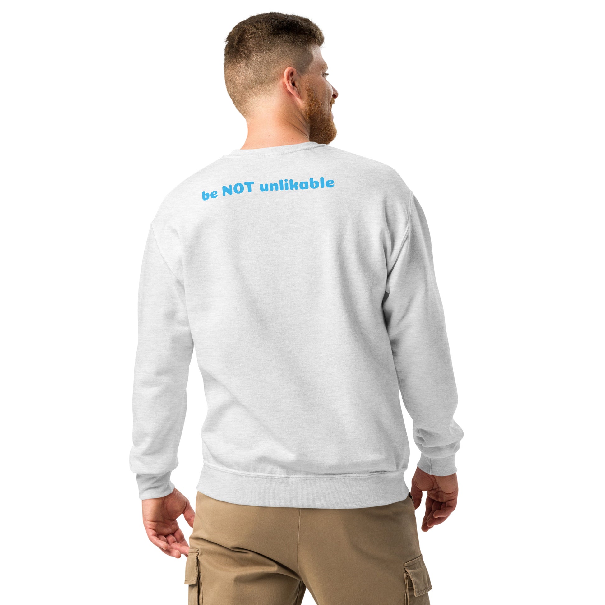 Man wearing a light gray sweatshirt with text on the back, standing against a white background