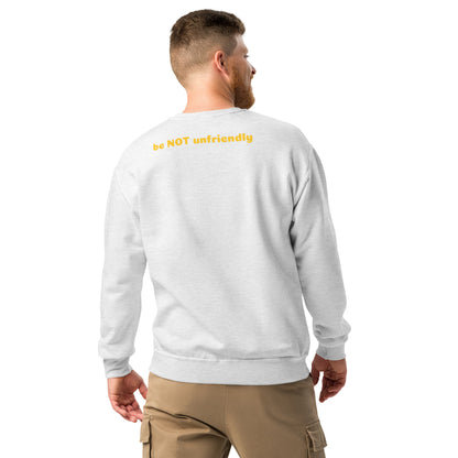 Man wearing a gray sweatshirt with yellow text on the back, standing against a white background