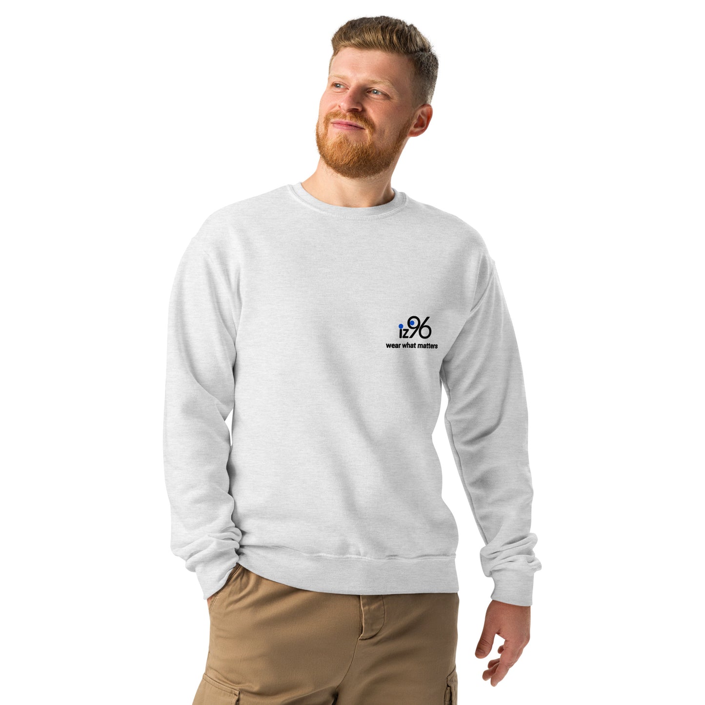 Man wearing a ash gray sweatshirt and beige pants on a white background