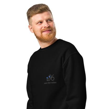 Man wearing a black sweatshirt with a logo on a white background