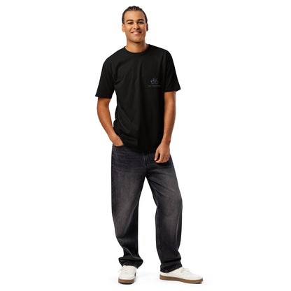 Man wearing a black t-shirt with a logo and dark jeans on a white background