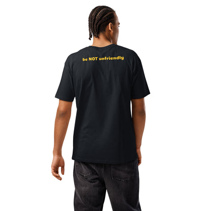 Person wearing a black t-shirt with yellow text on the back, standing against a white background