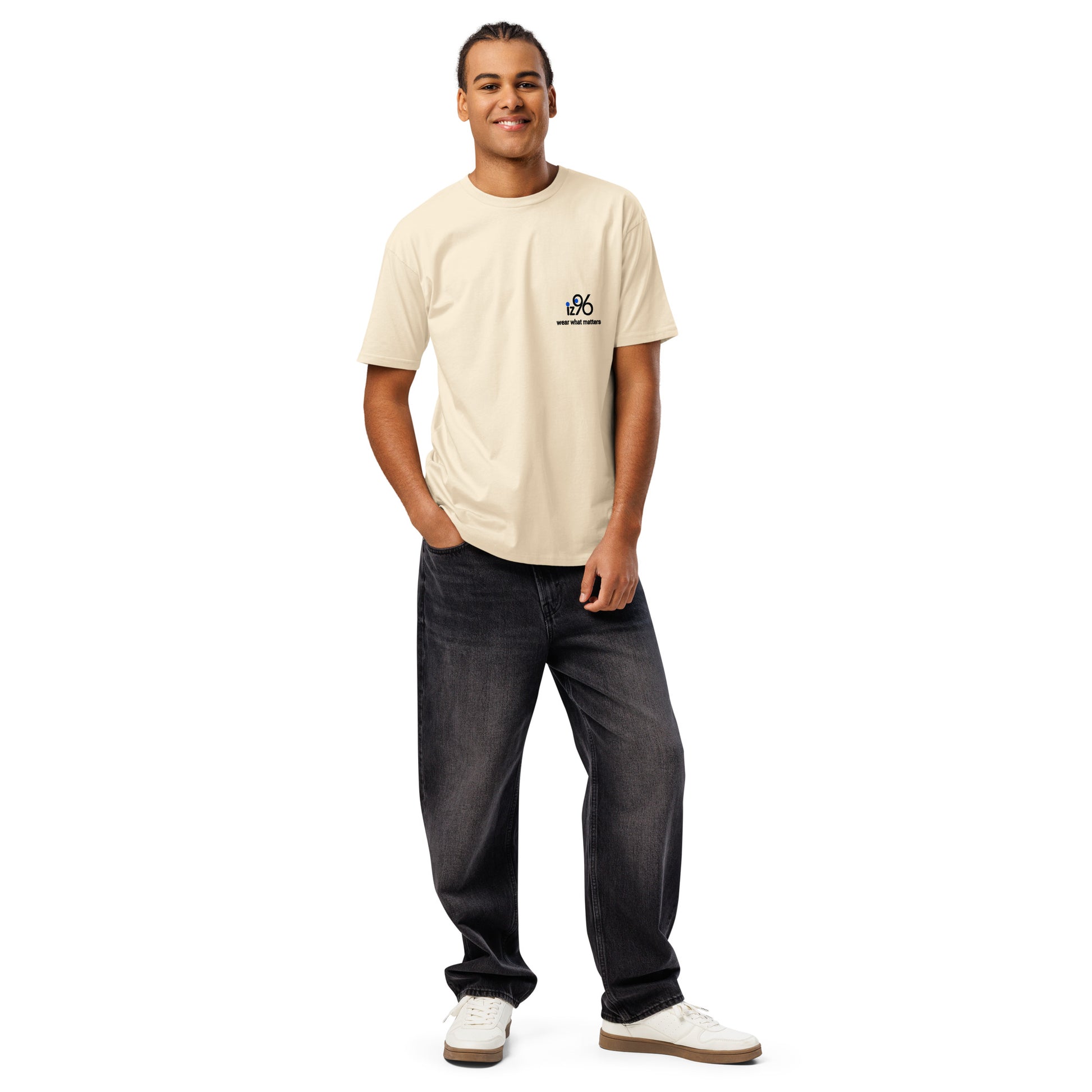 Man wearing a vintage white t-shirt and dark jeans on a white background