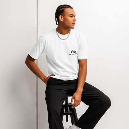 Person wearing a white t-shirt with 'Just Breathe' text, sitting on a stool against a plain background