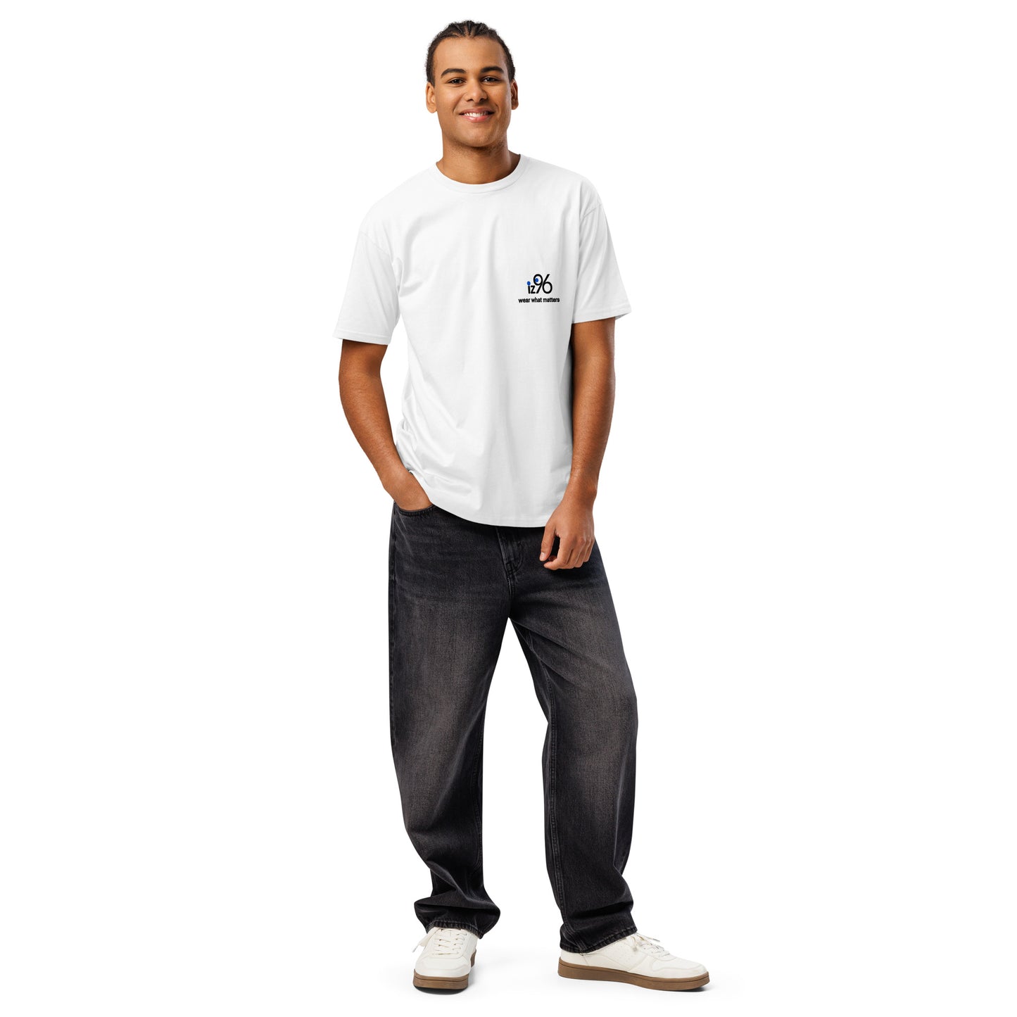 Man wearing a white t-shirt with a logo design and dark jeans on a white background