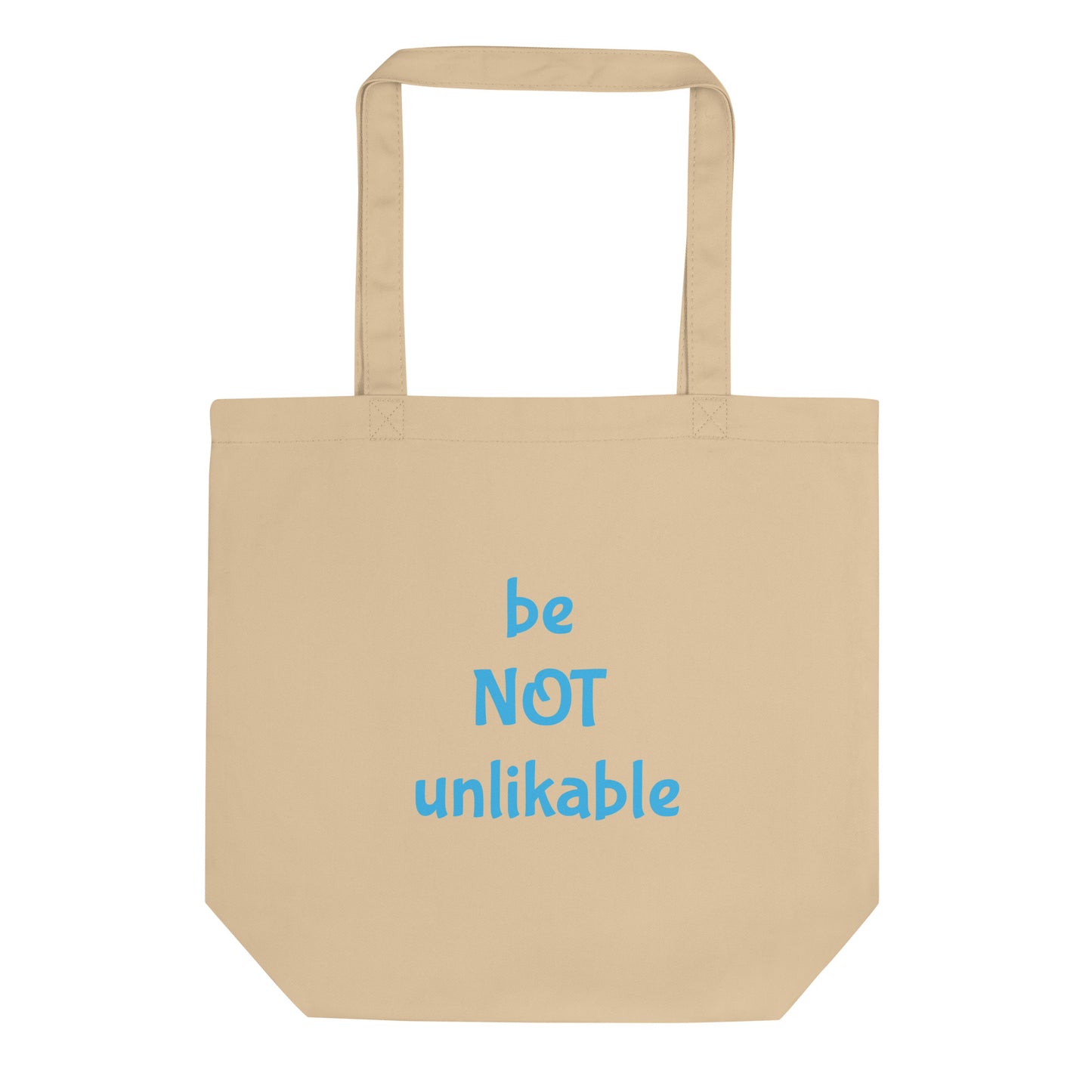 Beige tote bag with 'be NOT unlikable' text in blue on a white background