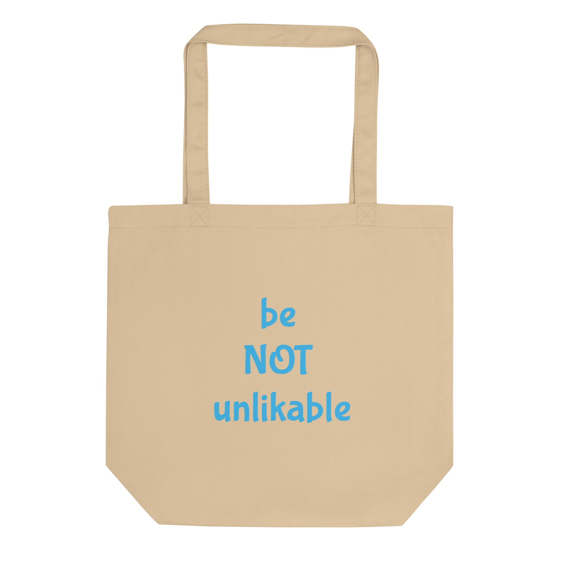Beige tote bag with 'be NOT unlikable' text in blue on a white background