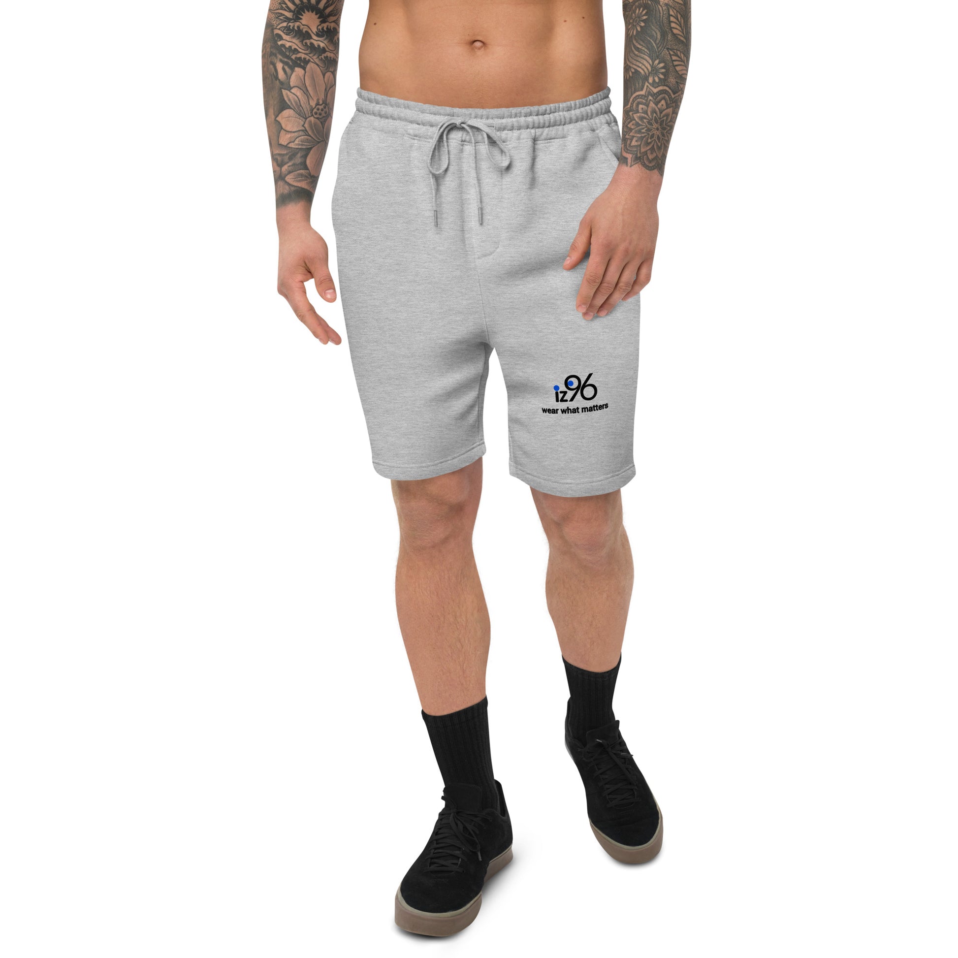 Person wearing gray sweat shorts on a white background