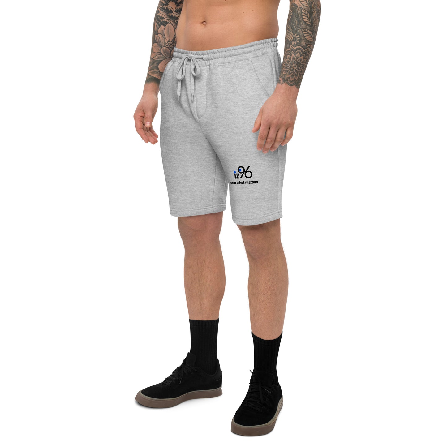 Person wearing gray shorts with a logo on a white background