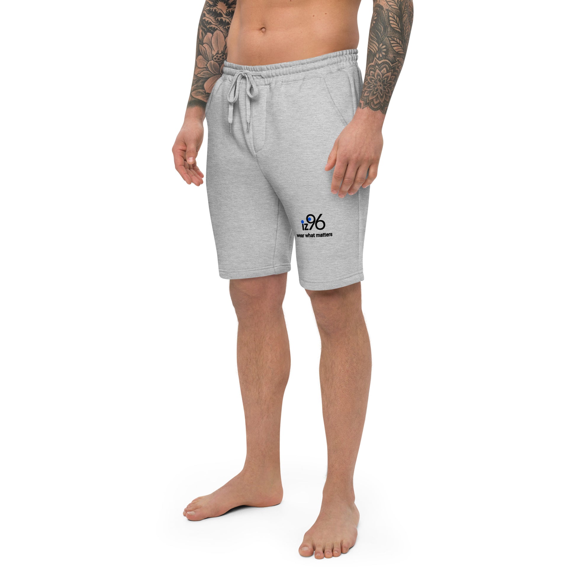 Person wearing gray shorts with a logo design on a white background