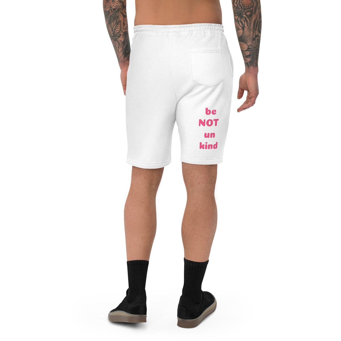 White shorts with pink text worn by a person on a white background