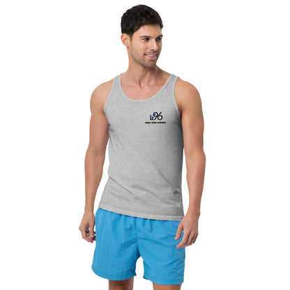 Man wearing a gray tank top with a logo and blue shorts on a white background
