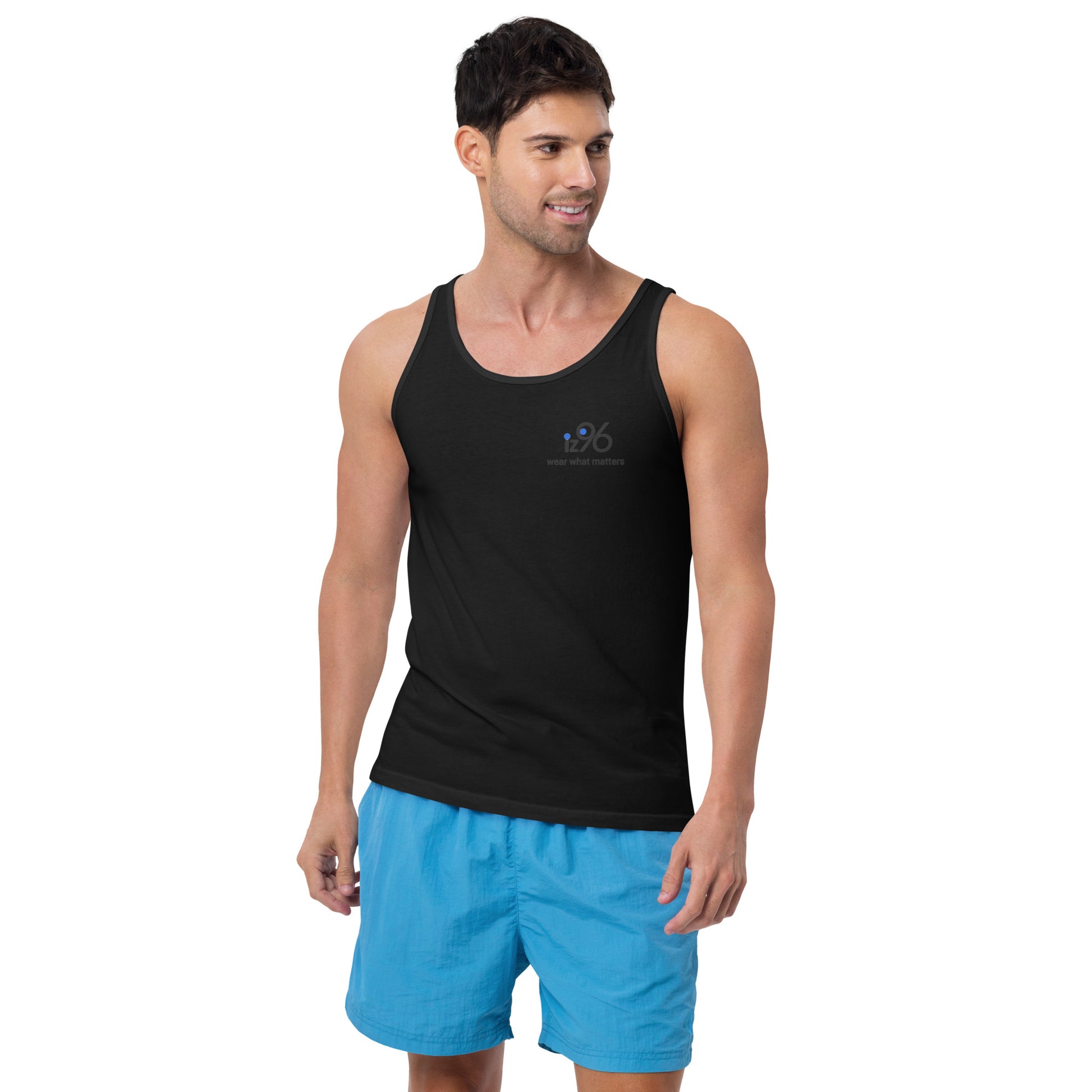 Man wearing a black tank top and blue shorts on a white background