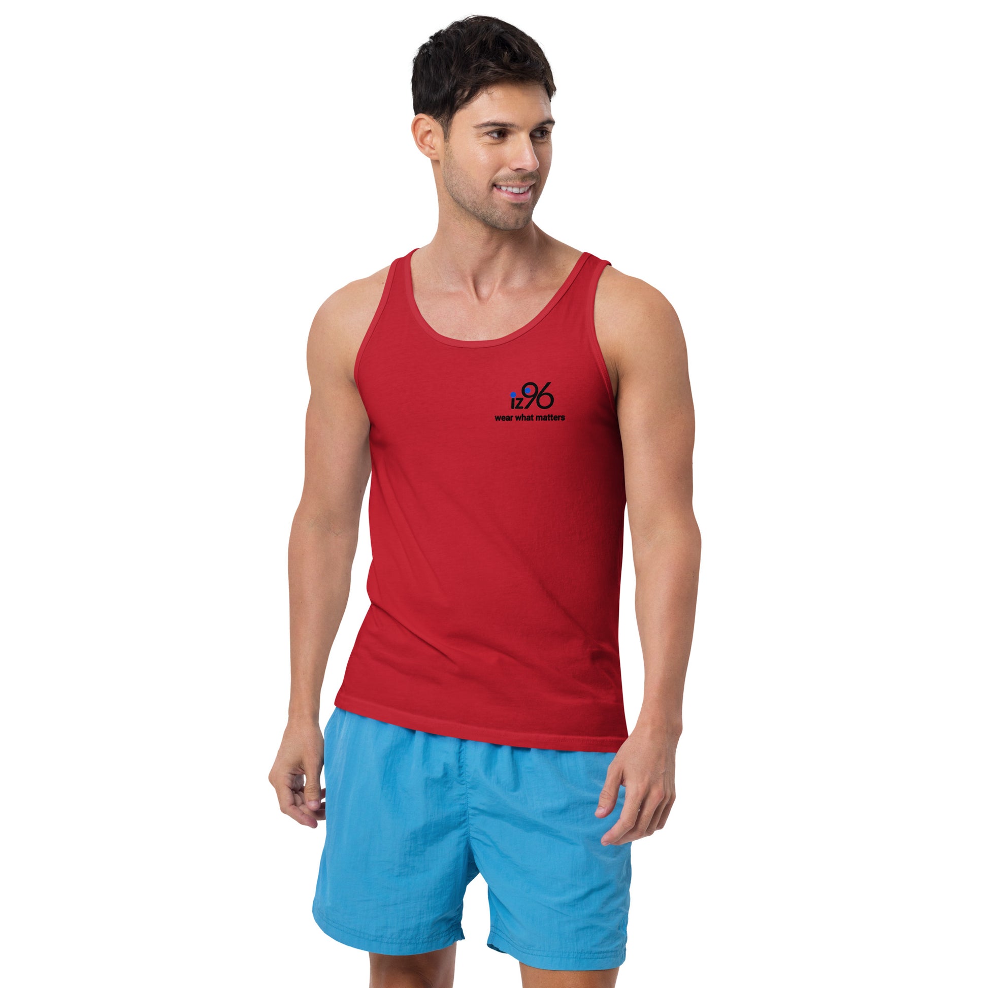 Man wearing a red tank top and blue shorts on a white background