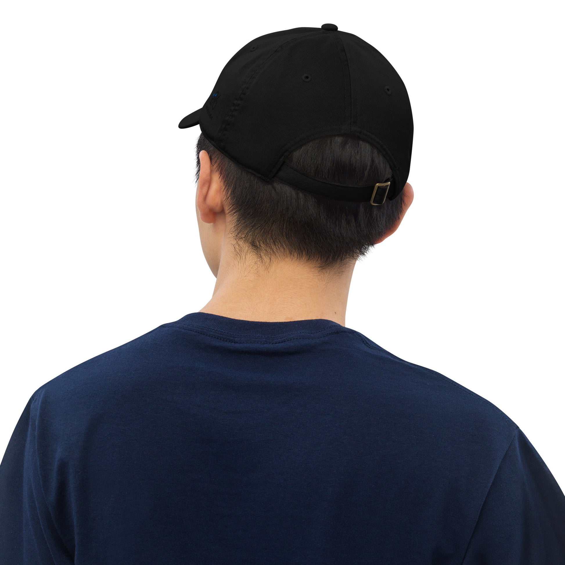 Person wearing a black cap and navy shirt on a white background
