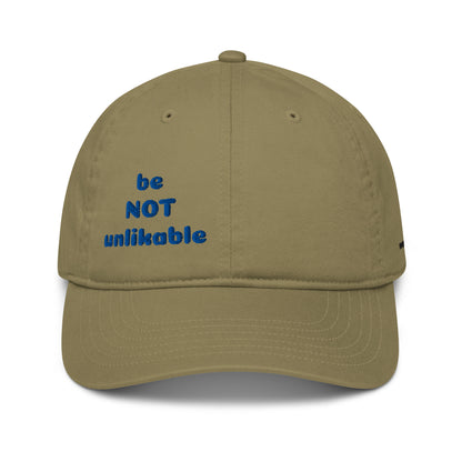 Khaki cap with 'be NOT unlikable' text in blue on a white background