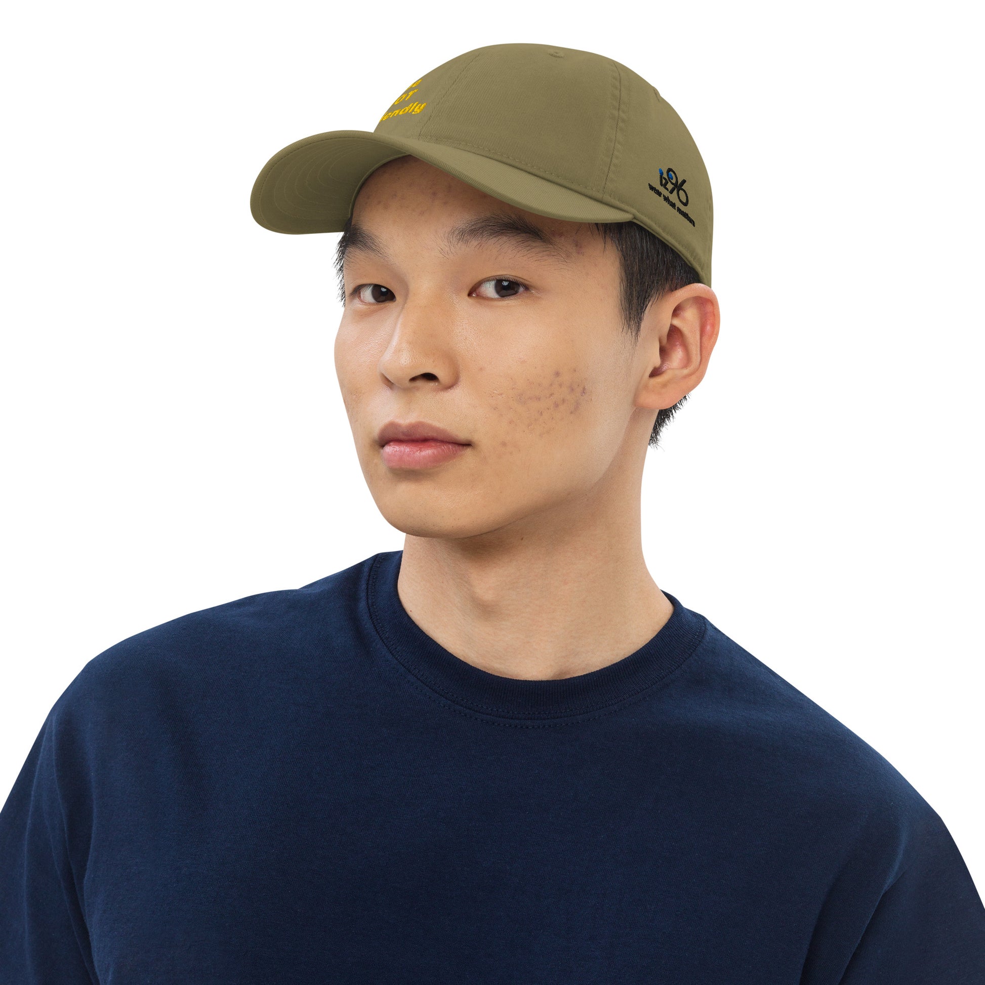 Person wearing a green cap and navy shirt on a white background