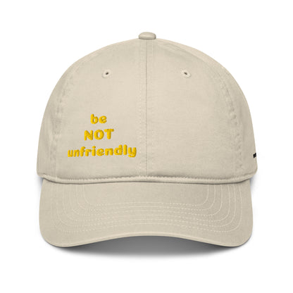 Beige cap with yellow text 'be NOT unfriendly' on a white background