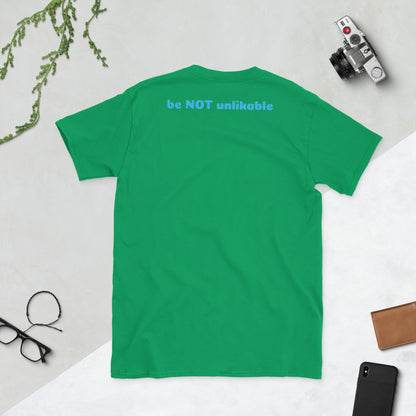 Irish green t-shirt with 'be NOT unlikable' text on a light gray background