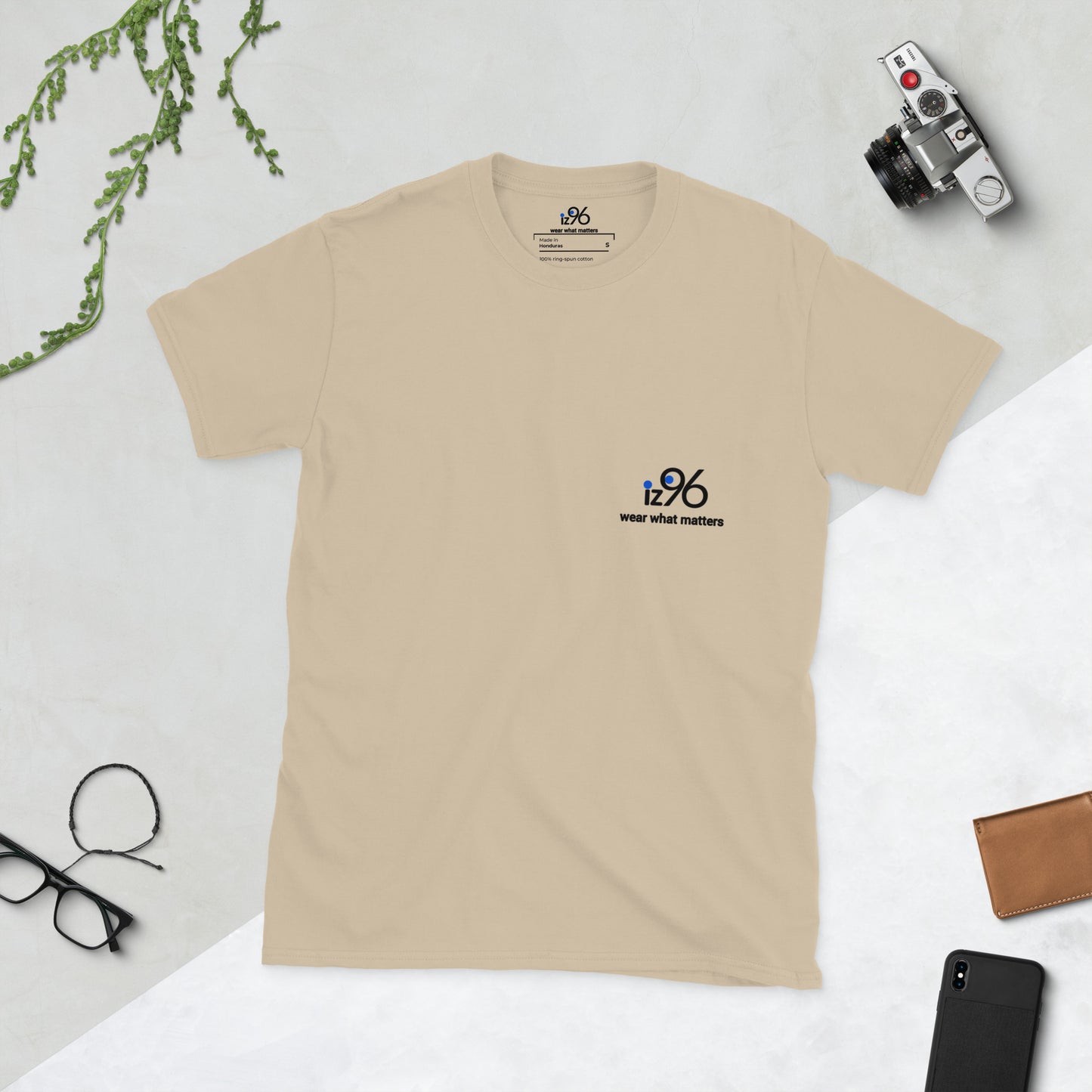 Beige t-shirt with a logo on a light gray background