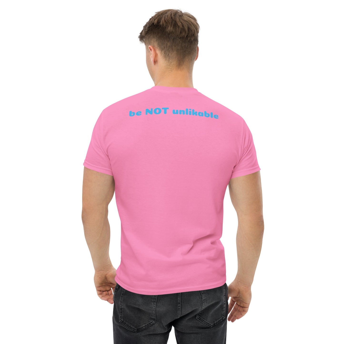 Person wearing a pink t-shirt with 'be NOT unlikable' text on the back, standing against a white background.