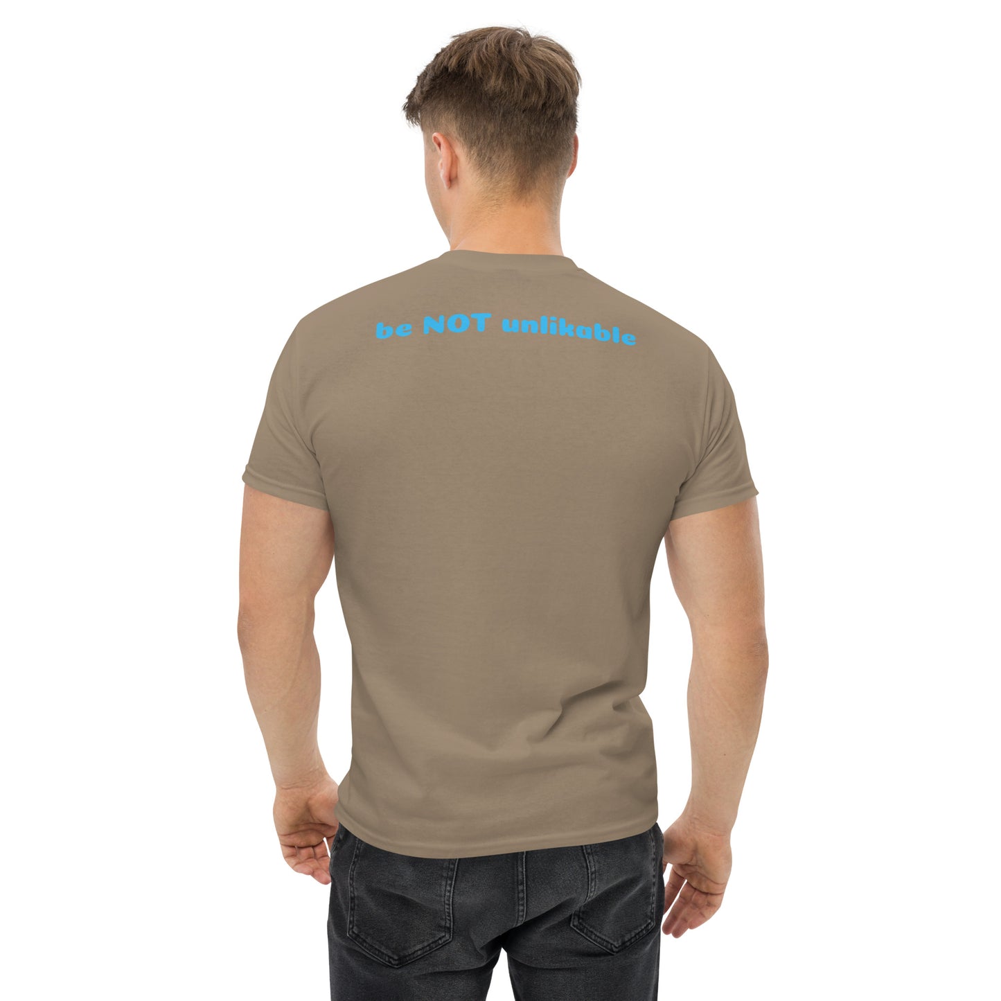 Man wearing a light brown t-shirt with 'be not unlikable' text on the back against a white background