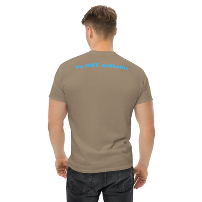 Man wearing a light brown t-shirt with 'be not unlikable' text on the back against a white background