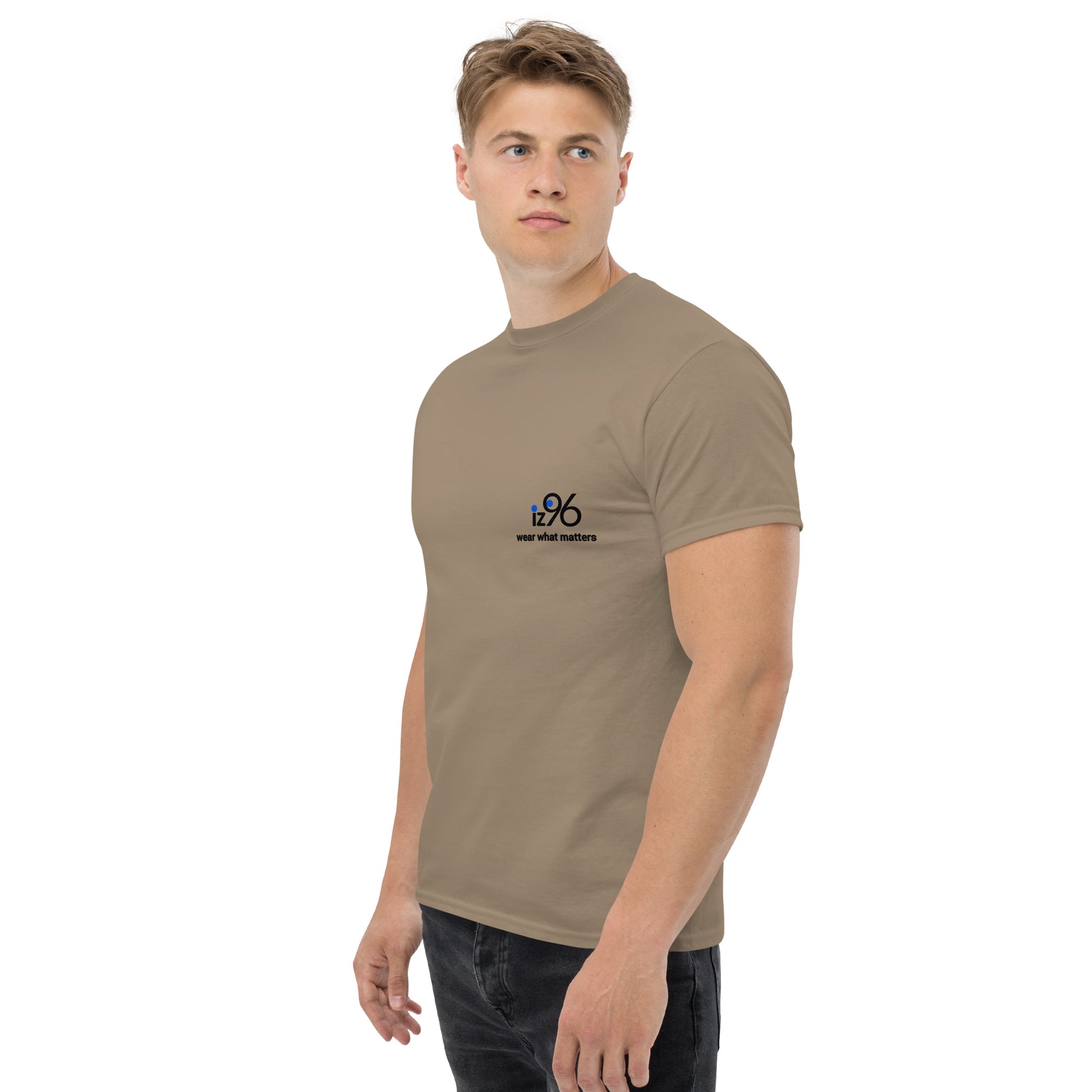 Man wearing a light brown t-shirt with a logo on a white background